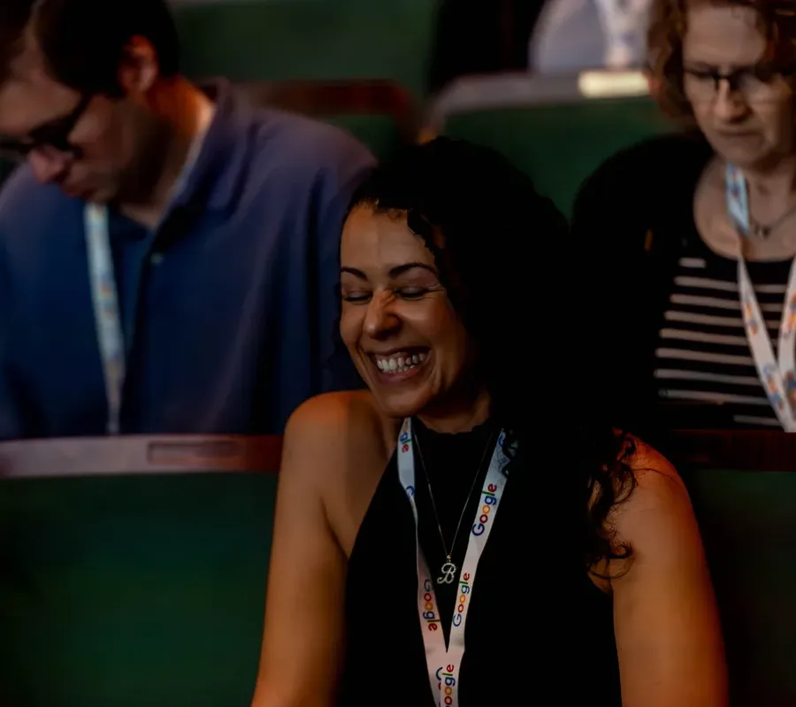 Smiling attendee during a session at All Things AI 2026