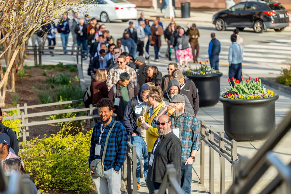 Attendees networking outside the Durham Convention Center at All Things AI 2026