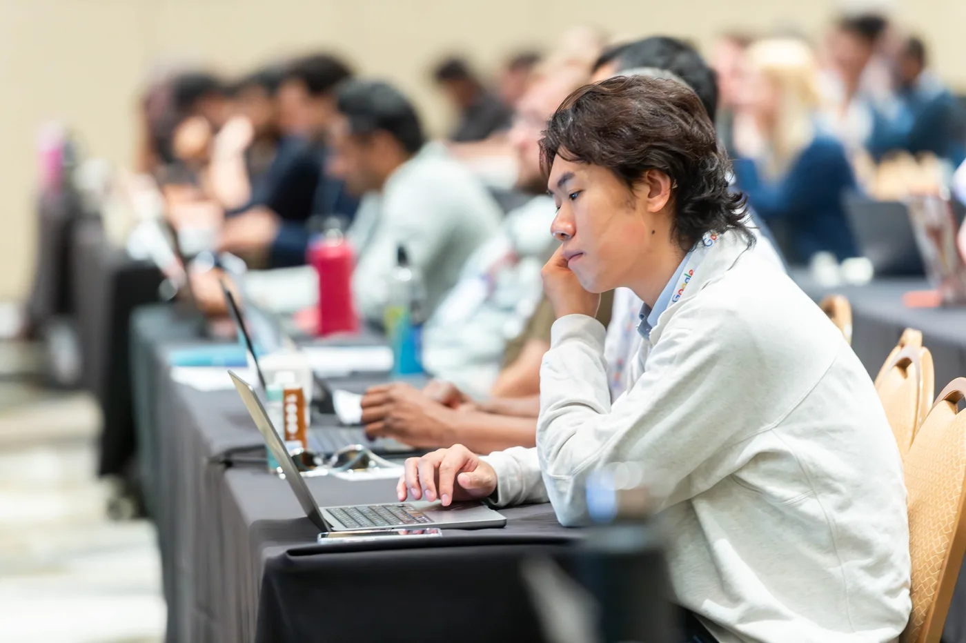 Attendees building with laptops open during an All Things AI 2026 workshop